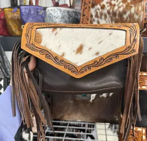 Genuine hand tooled leather & cowhide with fringe