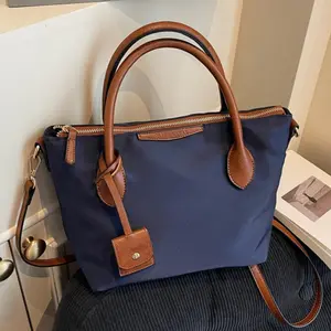 Nylon PU color-block handbag, multifunctional commuter crossbody bag, stylish casual shoulder bag for everyday use, waterproof lightweight nylon dumpling bag, women’s tote bag with adjustable shoulder strap.
