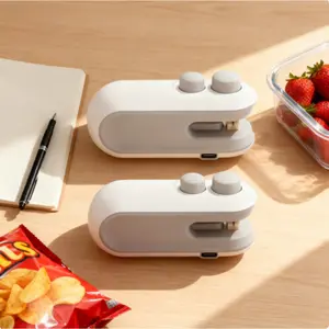 White Mini Sealing Machine! Comes with 2 units, featuring a 2-in-1 magnetic design. A rechargeable portable handheld heat vacuum sealer, perfect for resealing plastic bags and food crisp bags, making food storage effortless