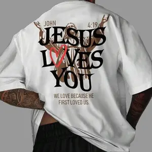 Jesus Loves You" John 4:19 Christian Bible Verse Graphic T-Shirt, Faith Quote Print Oversized Crew Neck Tee, Men's Short Sleeve Religious Cotton Top, Trendy Spiritual Aesthetic Shirt for Believers, Bible Fans and Streetwear Enthusiasts