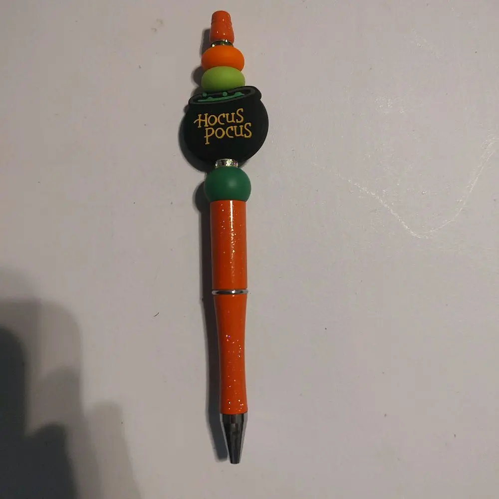 orange cauldron pen with words