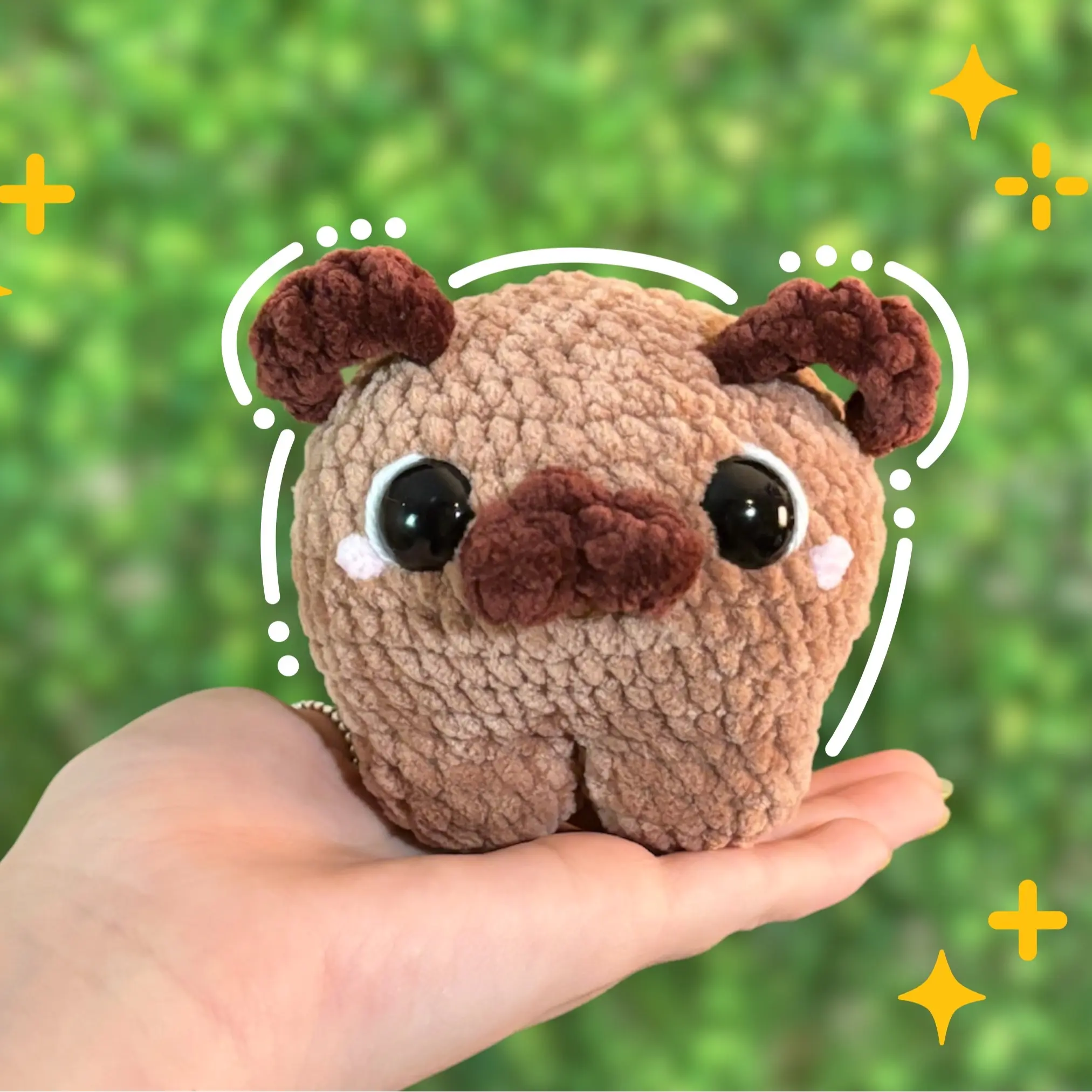 Handmade crochet soft and squishy Tan Chonky pug/dog with brown ears, tail, blush cheeks, white and black eyes and four legs.