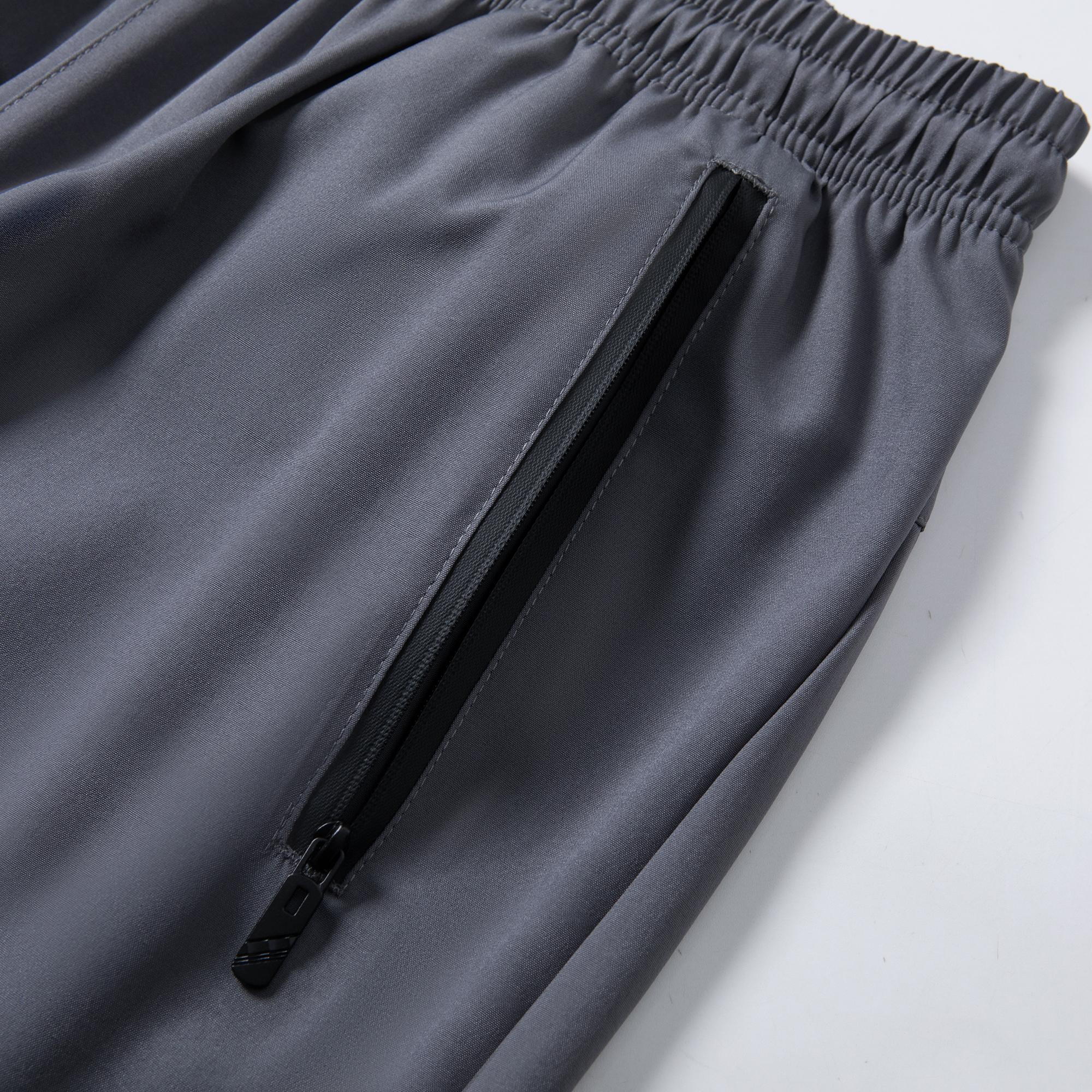 Men’s lightweight jogger pants with stretch fabric, 95% polyester, 5% spandex; elastic waistband with zippered pockets; breathable, quick-drying casual bottoms; men’s sports-casual jogger pants; machine washable.