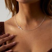 sideways  silver cross off center