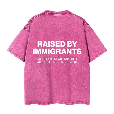 Women's Heavyweight Cotton Oversized Graphic Print Tshirt - "Raised By Immigrants" Back Slogan, Heartfelt Subtitle, Vintage Washed Blush Pink Short-Sleeve Round Neck Streetwear Casual Top (Pairable with Leggings), Lady