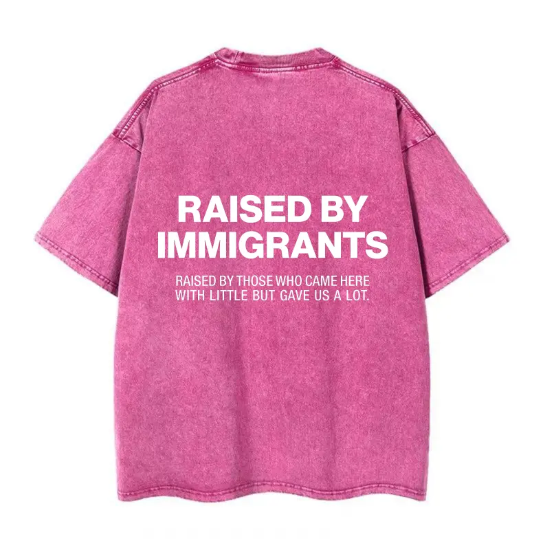 Women's Heavyweight Cotton Oversized Graphic Print Tshirt - "Raised By Immigrants" Back Slogan, Heartfelt Subtitle, Vintage Washed Blush Pink Short-Sleeve Round Neck Streetwear Casual Top (Pairable with Leggings), Lady