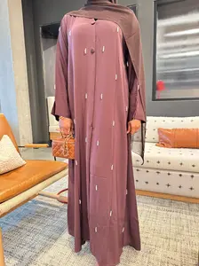 Elegant Brown Open Luxury Abaya – Hand-Embellished Grace  Step into timeless elegance with our exquisite Open Luxury Abaya in a rich mocha brown shade. Crafted from premium fabric that drapes effortlessly, Embroidered Muslim