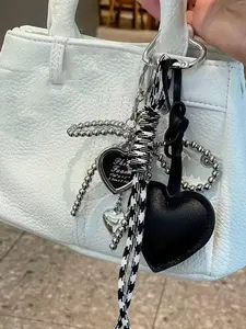 A niche, personalized, exquisite and fashionable love pendant decoration with a bow and love pendant. Designed with a woven hanging rope, it can be used as a bag hanging accessory, keychain, suitable for shopping, commuting, and gatherings