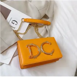 Orange Crossbody Bag with Gold Chain Strap and Logo Detail for Women's Fashion Accessories