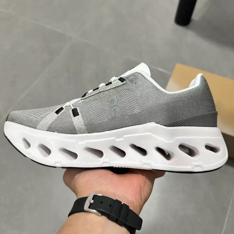 Stretch knit mesh hybrid lifestyle running trainers built for versatile soft neutral all-season urban fashion aesthetics, dense pale grey flexible knit shell layered with hollow creamy foam cushion structures, tightly reinforced stitching seams