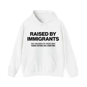 Raised By Immigrants Hoodie – Proud Heritage Motivational Quote Hoodie, Empowering Graphic Pullover, Trendy Unisex Streetwear Top, Comfort Cotton