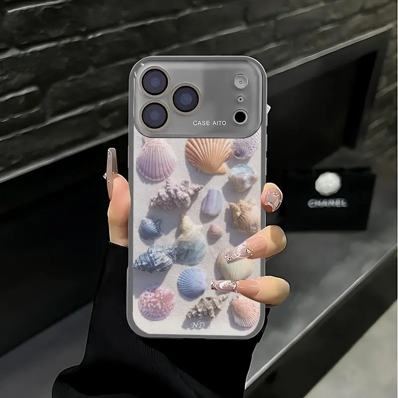 Beach-themed colorful seashell print phone case. Compatible with iPhone 17 Pro Max, 16 Pro Max, 15 Pro Max, and 14 Pro Max. Includes lens protection. Also compatible with iPhone 15, 14, 13, and 12. Made of skin-friendly TPU material.