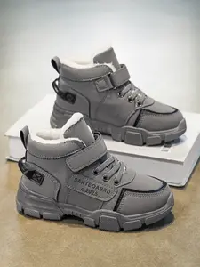 Children's winter sports shoes, fleece - lined cotton shoes. The upper is made of leather, and the inner lining is fleece. These are high - top shoes for boys, featuring a convenient hook - and - loop fastener design, which can keep warm and protect from