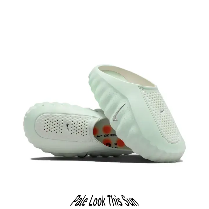 Streetwear slip-on kicks featuring smooth molded foam construction, mint pastel upper contrasted by orange rubber outsole studs, vintage minimalist silhouette that elevates every laid-back summer outfit