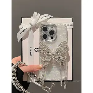 Crystal Rhinestone Bow Chain Case for iPhone 14/15 Series | Holographic Shell Base + 3D Large Crystal Rhinestone Bow + Rhinestone Lens Bezel + Beaded Chain Lanyard | Scratch & Shock Resistant | Outing/Party Luxury Shiny Girl Style
