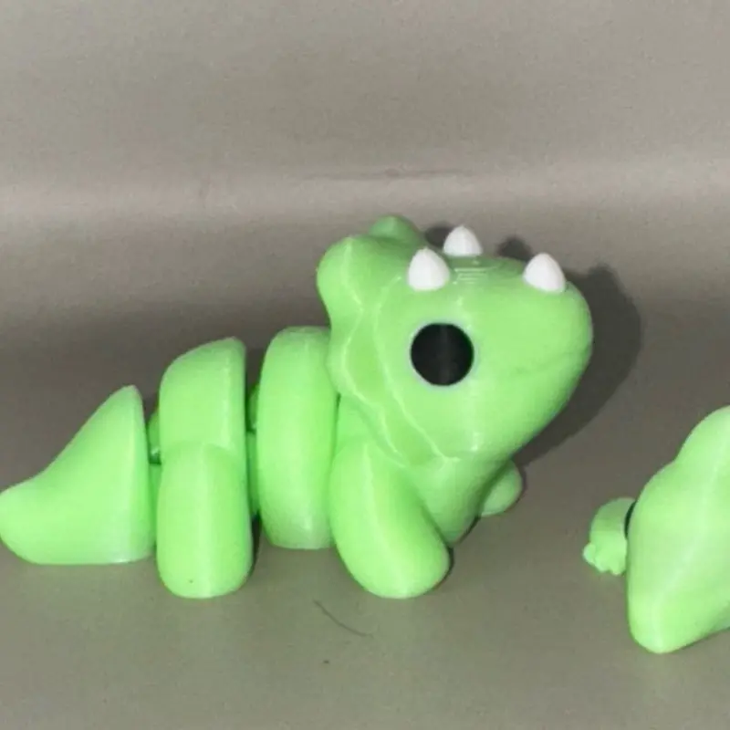 3D Printed Triceratops Green Toy with Dinosaur Features and Unique Design Elements