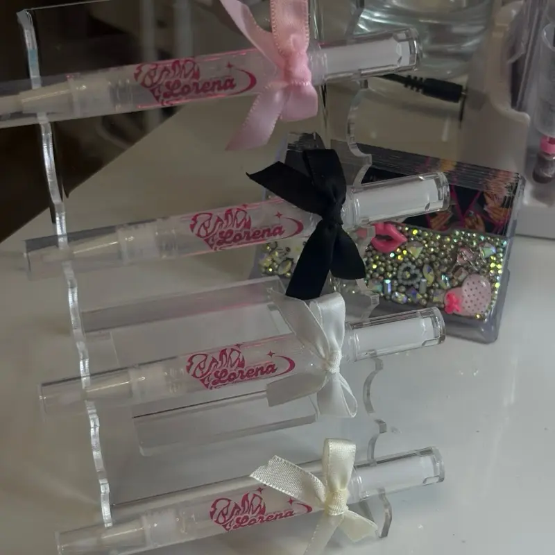 Lorena XO Nails Cuic - Product with Bow Decor and Branding Elements,  Cuticle Oil – Nail & Cuticle Care  Keep your nails healthy, hydrated, and glowing with our nourishing cuticle oil.  Infused with natural oils and vitamins, it helps:  Moisturize &