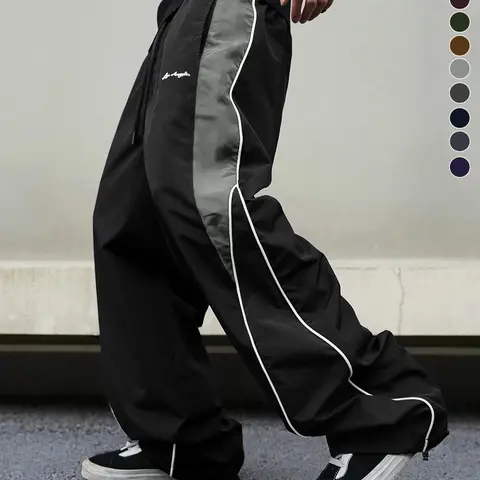Men’s black wide-leg casual athletic pants made from wrinkle-resistant woven fabric, featuring a drapey long floor-length cut, an elastic wide drawstring waist, and clean, extended wide legs; suitable for campus commuting and Korean high-street street sty