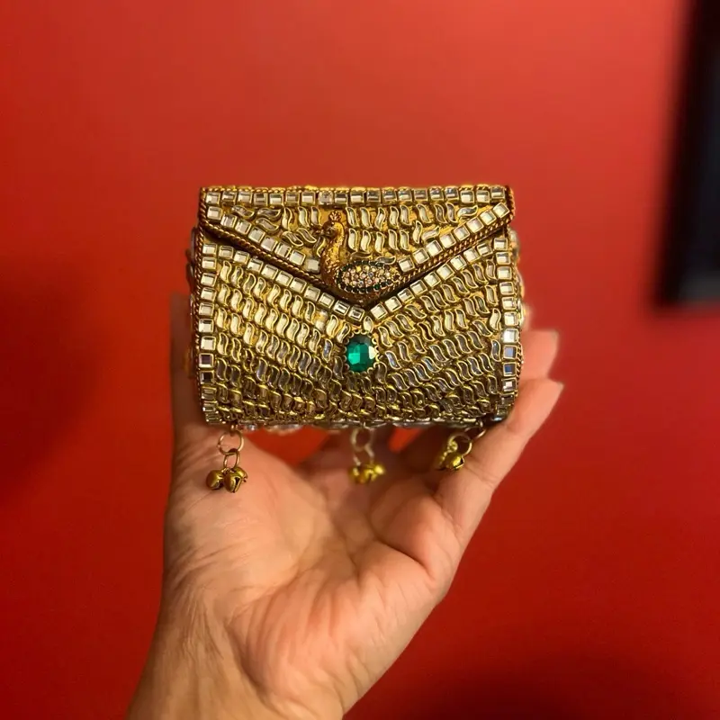 Green Ghungru Kundan Clutch - Elegant Gold-Plated Design with Emerald Accent and Bell Charms