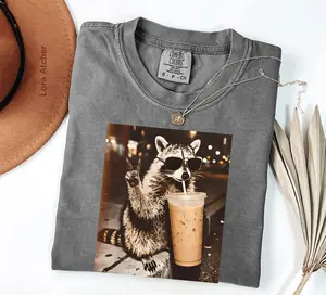 Raccoon Drinking Iced Coffee shirt, Coffee Raccoon shirt, Funny Animal Meme shirt, Retro Prehistoric shirt, Gift For Animal Lover, 4th of July shirt - LORA ATCHER