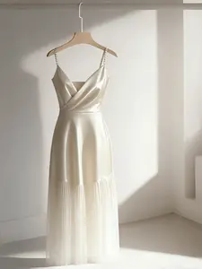 A women's light mature style apricot suspender long dress with pearl shoulder straps and fashionable splicing mesh pleated dress, suitable for all seasons, suitable for home, indoor, and outdoor wear