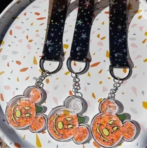 Pumpkin head shaker keychains with a black sparkly star vinyl strap!