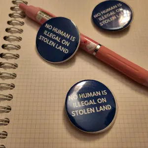 No Human is Pin - Blue with White Text - Ideal for Activism and Support for Human Rights