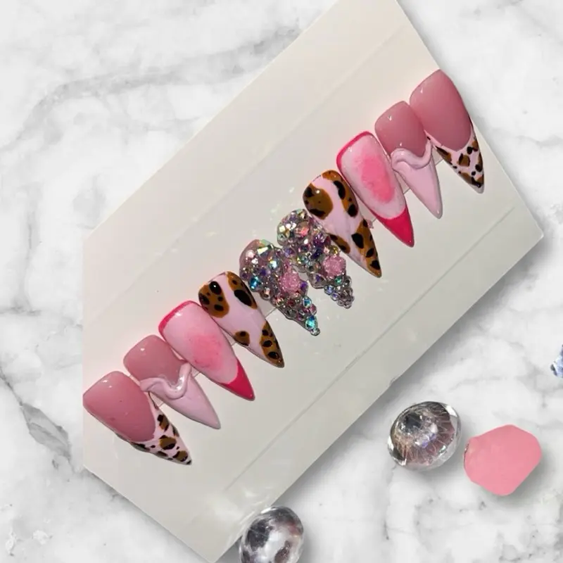 ‘ I’m ready to conquer the World ‘ vibes - these nails are absolutely stunning!  The mix of pink and leopard print is so chic, and those crystals add the perfect touch of sparkle.