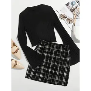 Women’s two-piece set featuring a plain ribbed long-sleeve top and a checkered print skirt; an elegant and fashionable casual outfit suitable for everyday outdoor wear, ideal as autumn and winter womenswear.