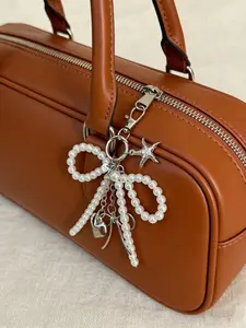 Neutral Y2K cute bead bow pendant, fashionable heart-shaped large bag pendant, silver heart-shaped rotating hook design, spring clasp, starfish, bow, and heart-shaped elements phone charm keychain