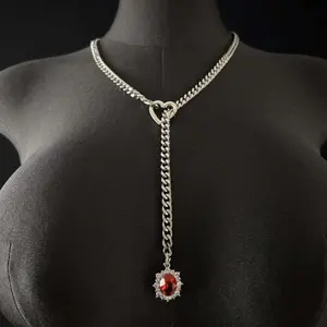 Unique design vintage gold necklace with heart-shaped ruby pendant layered with Cuban chain necklace