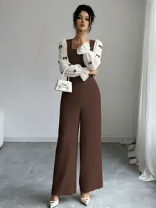 A women's coffee-colored contrast splicing design sense square-neck white puffy-sleeve bow decoration flared cuff overalls, suitable spring and autumn, suitable for daily commuting and home wear.