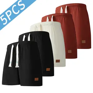 Men’s waffle-textured casual shorts 5-piece set featuring a drawstring elastic waistband and minimalist leather tag design; versatile for everyday commuting and activewear, available in multiple colors.