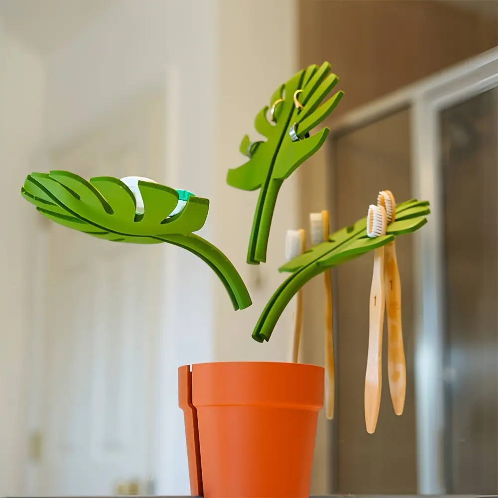 Modern Monstera Leaf Bathroom Storage Rack – Space-saving wall-mounted toothbrush and toothpaste holder with storage box, adorned with green leaf patterns, Toothbrush Organizer