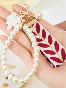 A fashionable and elegant pearl leaf striped ribbon bracelet keychain, Floral Pattern Keychain, Keychain Jewelry, accessory, suitable for daily outfit matching, and also a surprising exquisite small gift.