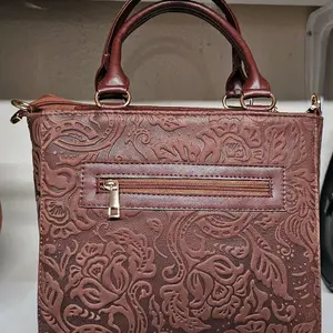 Elegant Brown Leather Handbag with Intricate Floral Embossing and Zipper Closure for Daily Use or Special Occasions
