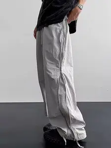 One piece men’s casual long pants featuring a side full length zipper and drawstring, wide leg design; urban relaxed style. Semi sheer ruched fabric paired with a side long mesh lining with zipper; loose drape and fit. Suitable for men for shopping, explo