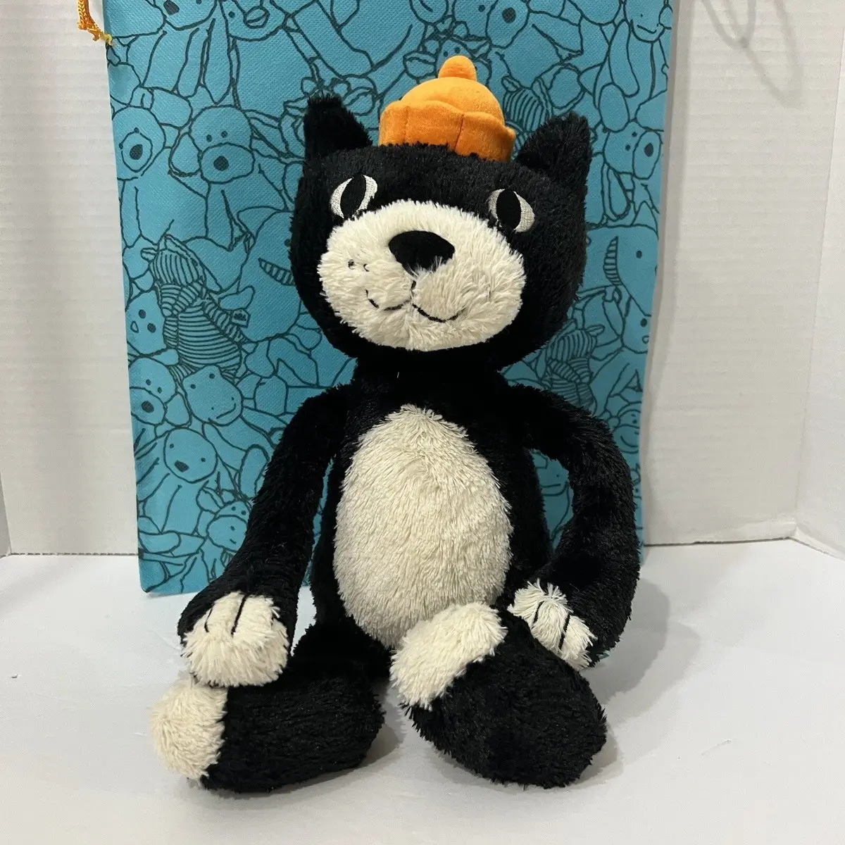 Jellycat Jack plush cat – an iconic mascot character featuring a soft orange hat shaped like a jelly mold; available in seated, crossbody, and keychain versions.