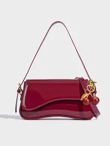 patent leather baguette underarm bag, U-shaped metal buckle cherry pendant, retro shoulder bag, Elegant Bag, niche fashion design, versatile and suitable for daily office workers commuting, shopping, dating, afternoon tea, etc.
