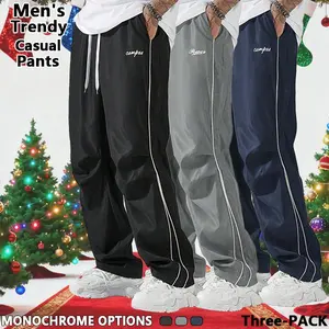 Loose-fitting men's sweatpants with grey side stripes and gold accent stripes. Comfortable design, sports casual style bottoms, sweatpants, fitness wear for all seasons.