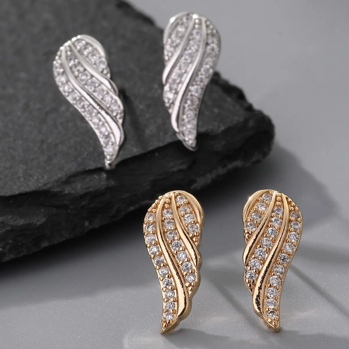 Light luxury spiral stud earrings adorned with diamonds, featuring feather wings—versatile and exquisite.