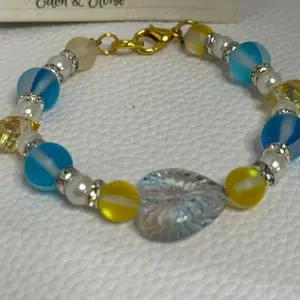 Handmade Beaded Bracelet with Blue Heart Charm and Yellow, White Beads