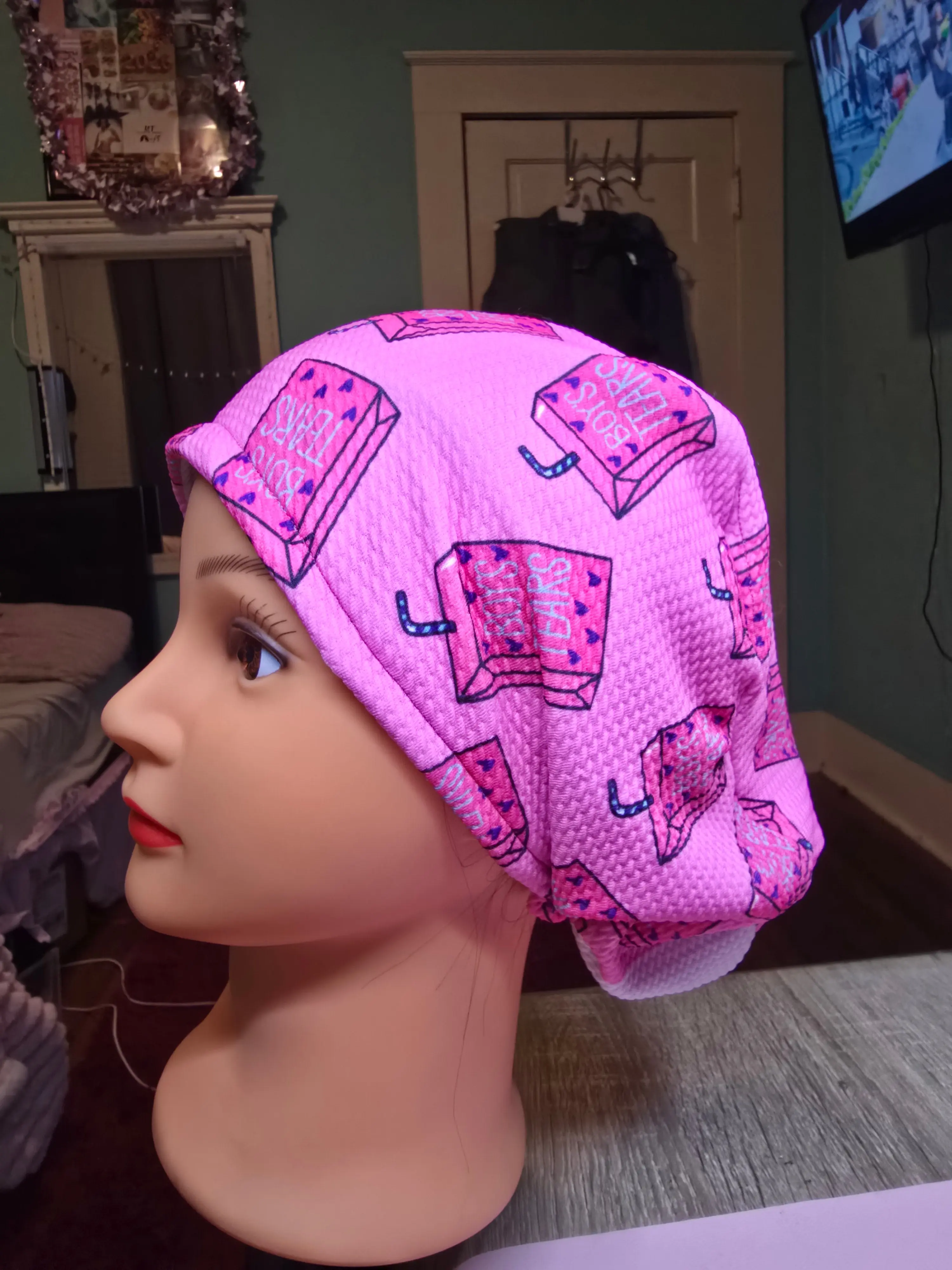 Boy tears scrub hat