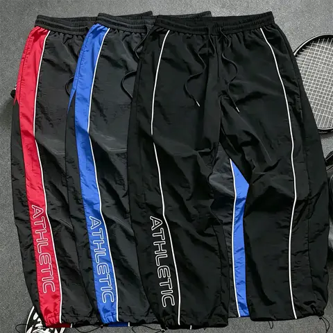 Men’s athletic casual pants with an elastic drawstring waistband and color-block design; suitable for fitness, outdoor sports, running, and casual wear. Men’s casual pants, men’s long pants, menswear.