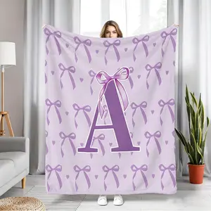 Purple Flannel Blanket With Bow and Letter Print. High-Definition Digital Printing Ensures Vibrant Colors. Solidly Crafted, Durable, and Resistant to Pilling. Fluffy, Soft, and Gentle, This Versatile and Warm Blanket Is Perfect for A Girly Look.