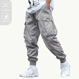 Men’s casual athletic jogger pants with elastic cuffs at the legs, ultra-thin breathable fabric, sport style, beige/black/khaki colors, multifunctional pockets, drawstring waist, lightweight soft polyester fiber, camouflage pattern for outdoor running.