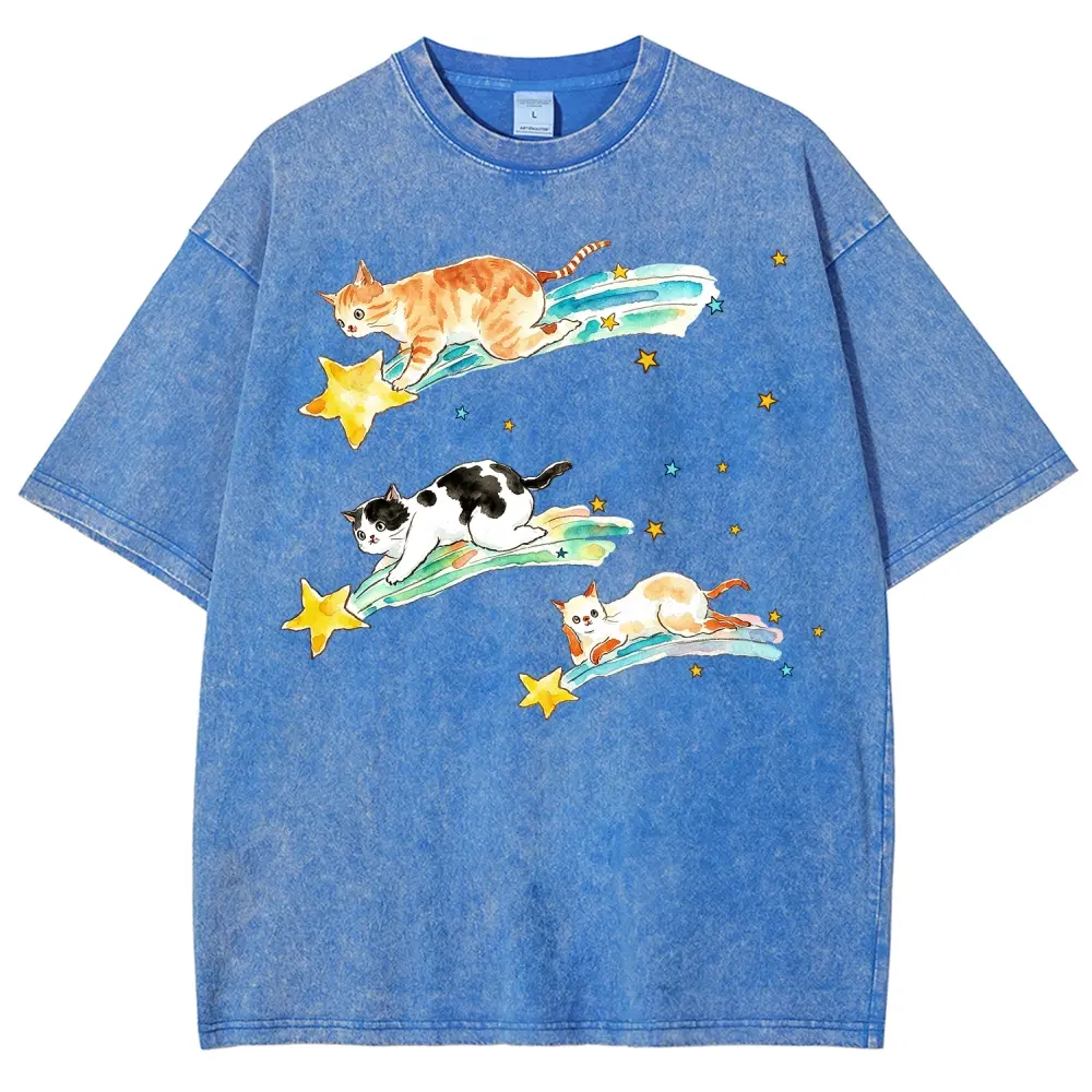 Y2K Kawaii Hand Drawn Watercolor Illustration Of Three Different Coat Pattern Kittens Sliding Down Glowing Shooting Star Comets, Scattered Tiny Yellow & Light Blue Star Accents Kawaii Cosmic Pet Lover Unisex Loose Fit Casual Streetwear Tee