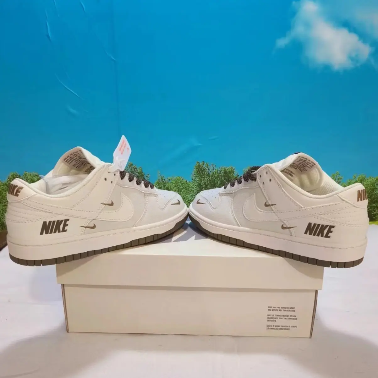 Creamy off-white bronze multi mini logo embossed retro low-top sneakers featuring scuff-proof dual-tone dark olive off-white layered vintage gum rubber outsoles, tear-resistant sweat-wicking soft perforated full-grain leather construction