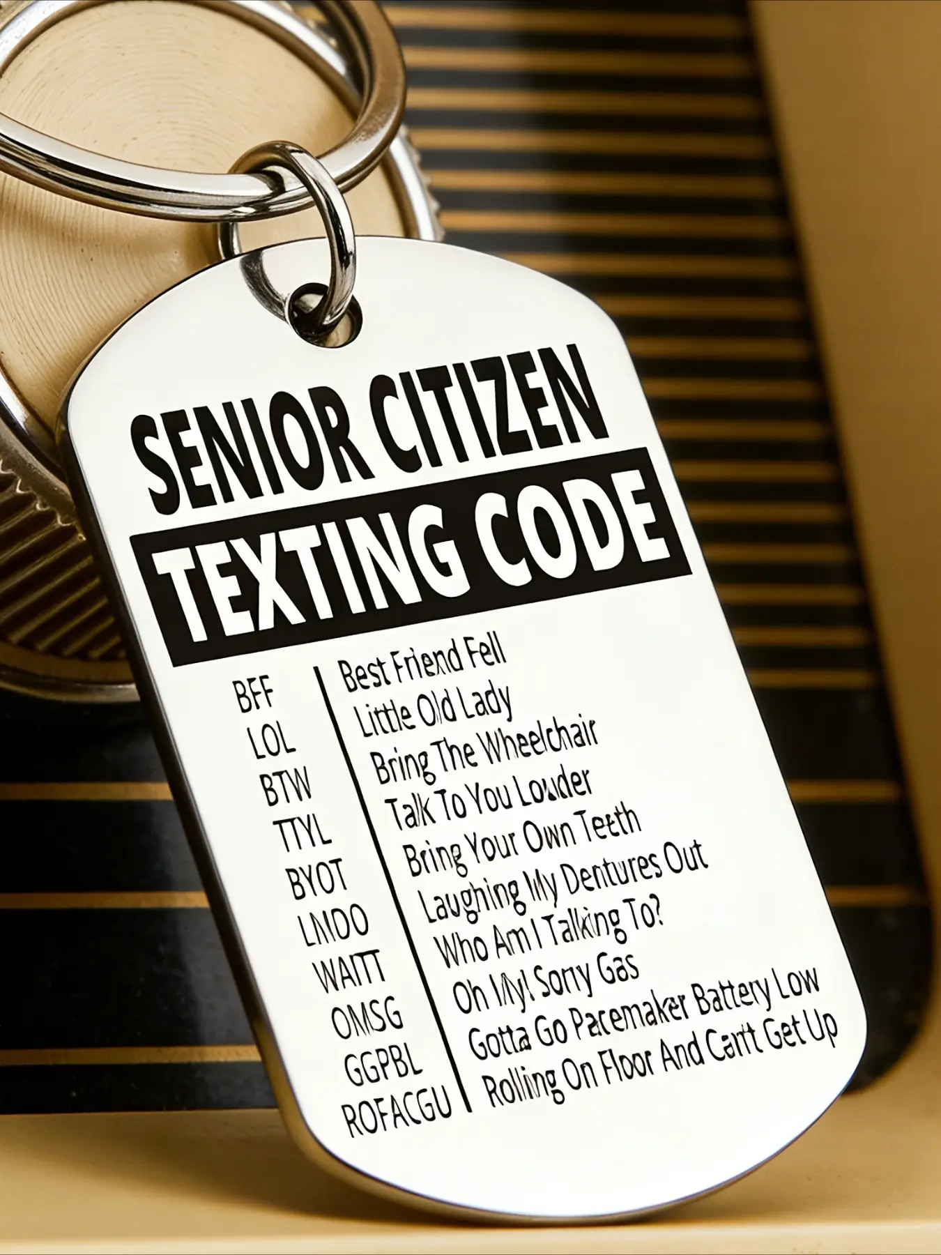 A fun keychain for seniors, engraved with the full text of the "Senior Texting Code," makes for a humorous gift suitable for both men and women. Durable and practical for everyday use, it’s perfect for retirement celebrations and family gatherings.