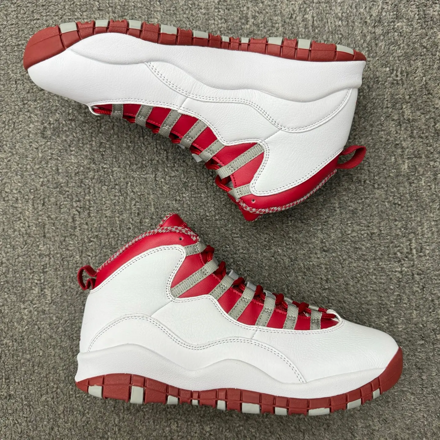 Retro hip‑hop vibe couple high‑top street basketball sneakers, classic white pebbled leather upper red‑grey striped design red rubber outsole, shock‑absorbing cushioned midsole, fashionable shoes fit for commute and street shoot